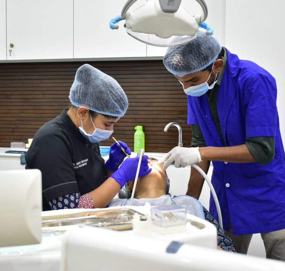Dentist and dental assistant performing a dental treatment on a patient in a modern dental clinic using advanced equipment.